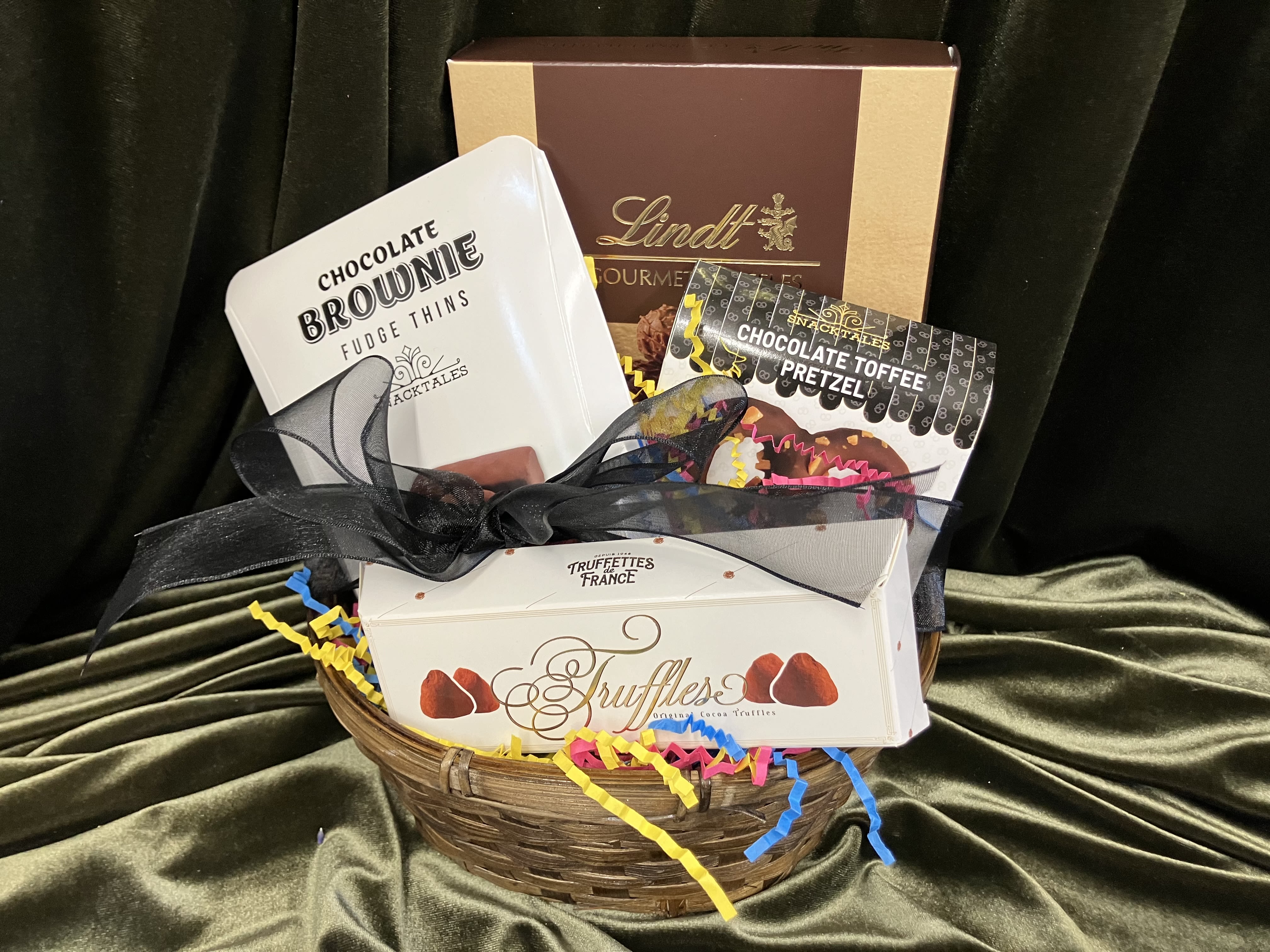 Mini Chocolate Lovers Basket - A perfect gift for anyone that loves chocolate!! Basket has 4 different types of chocolates including Lindt truffles, brownie bites, dusted truffles and a chocolate covered pretzel! Tied with classy black ribbon. 