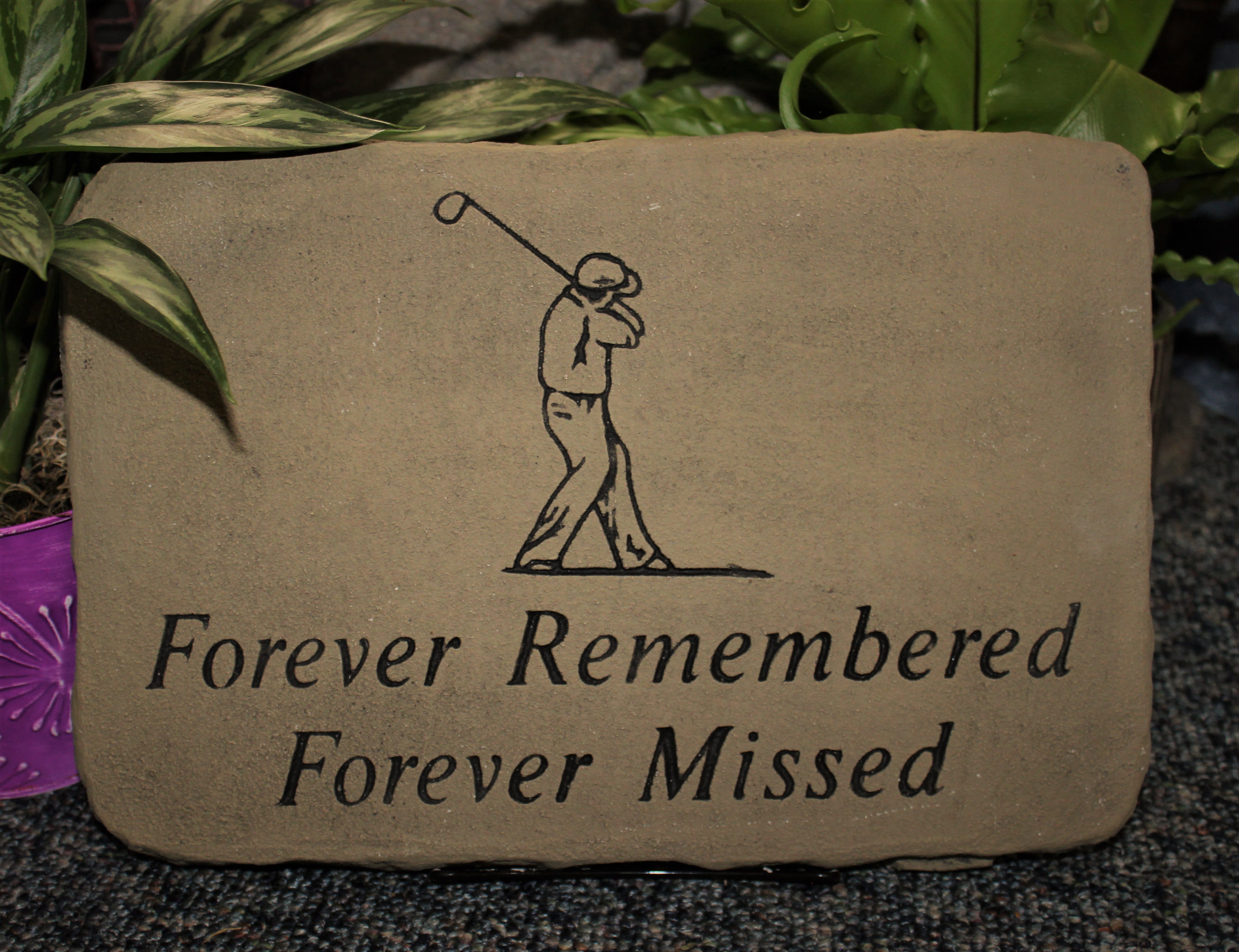 Memorial stone with a golfer illustration and the words Forever Remembered Forever Missed