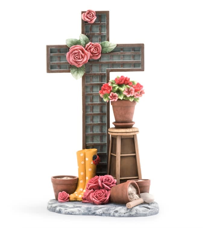 Decorative cross with pink roses and a potted flower arrangement