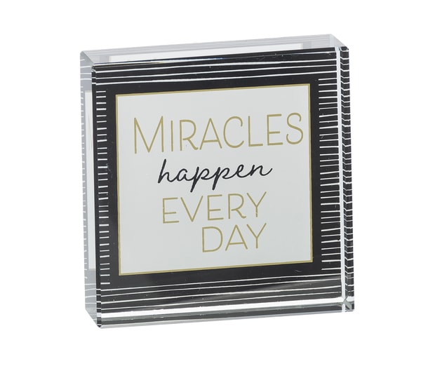 Decorative sign with the words "Miracles happen every day"