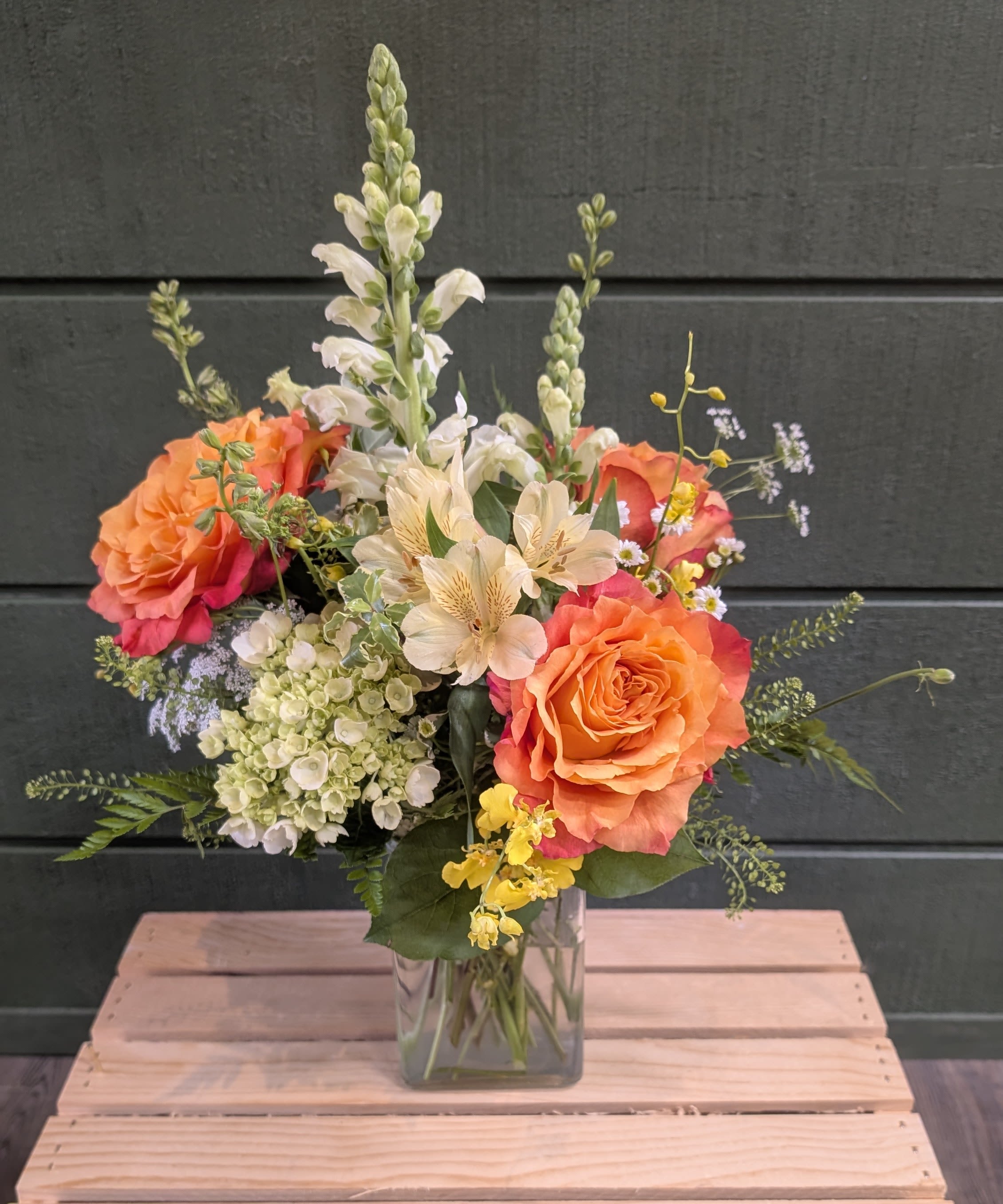 Ray of Sunshine - THE COMBINATION OF ROSES AND ALSTROEMERIA WITH TALL WHITE SNAPDRAGON SPIKES AND PALE HYDRANGEA CLUSTERS CREATES A LAYERED, UPRIGHT COMPOSITION.
