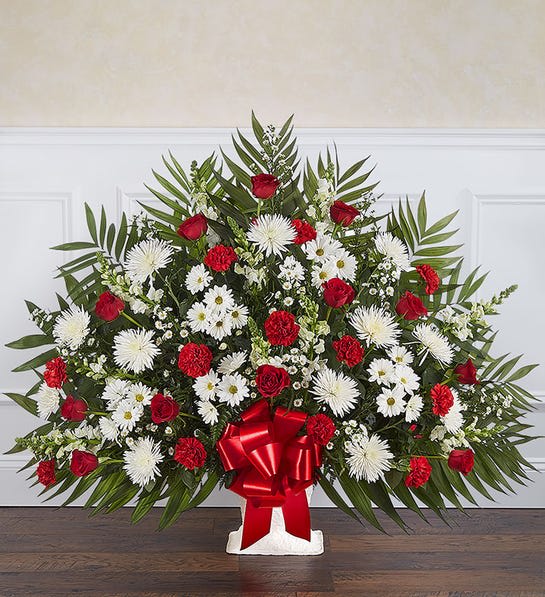 Large red and white floral spray with a red ribbon bow