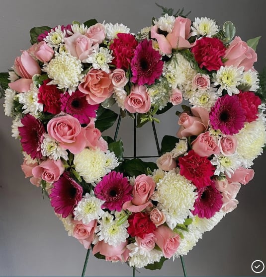 Heart-shaped floral wreath with pink roses, white mums, and magenta gerberas