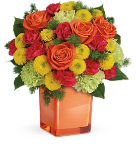 Orange roses and red-yellow mums in a square glass vase