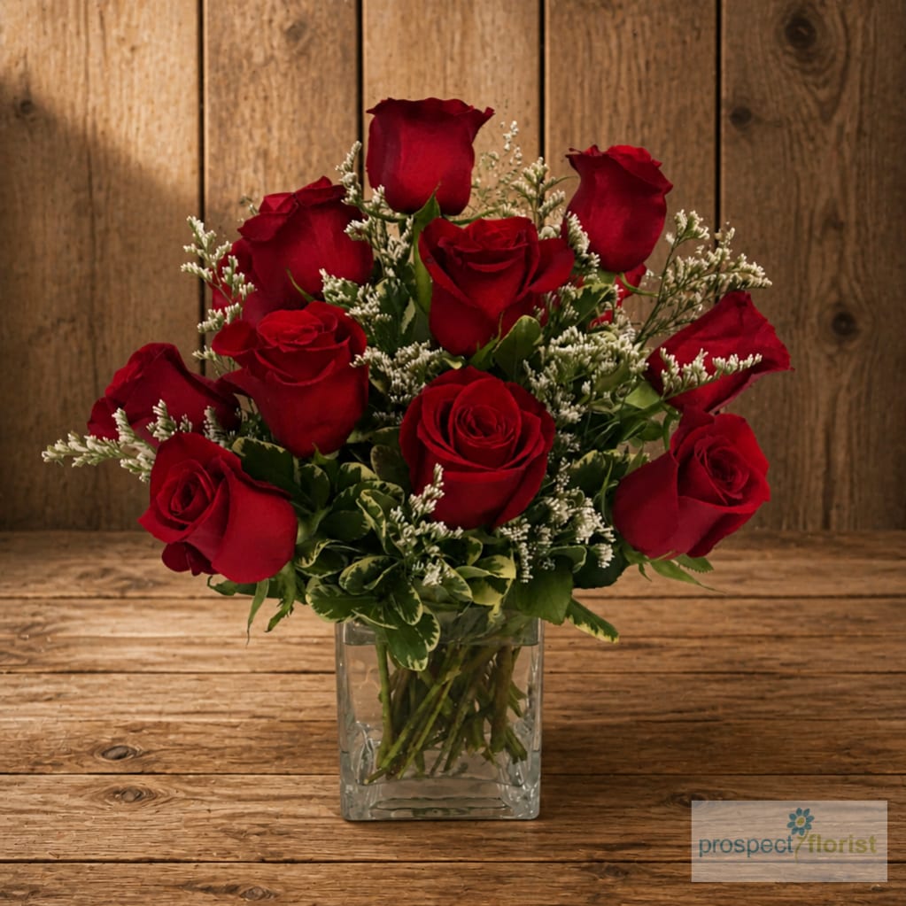 Red roses arranged in a clear square vase