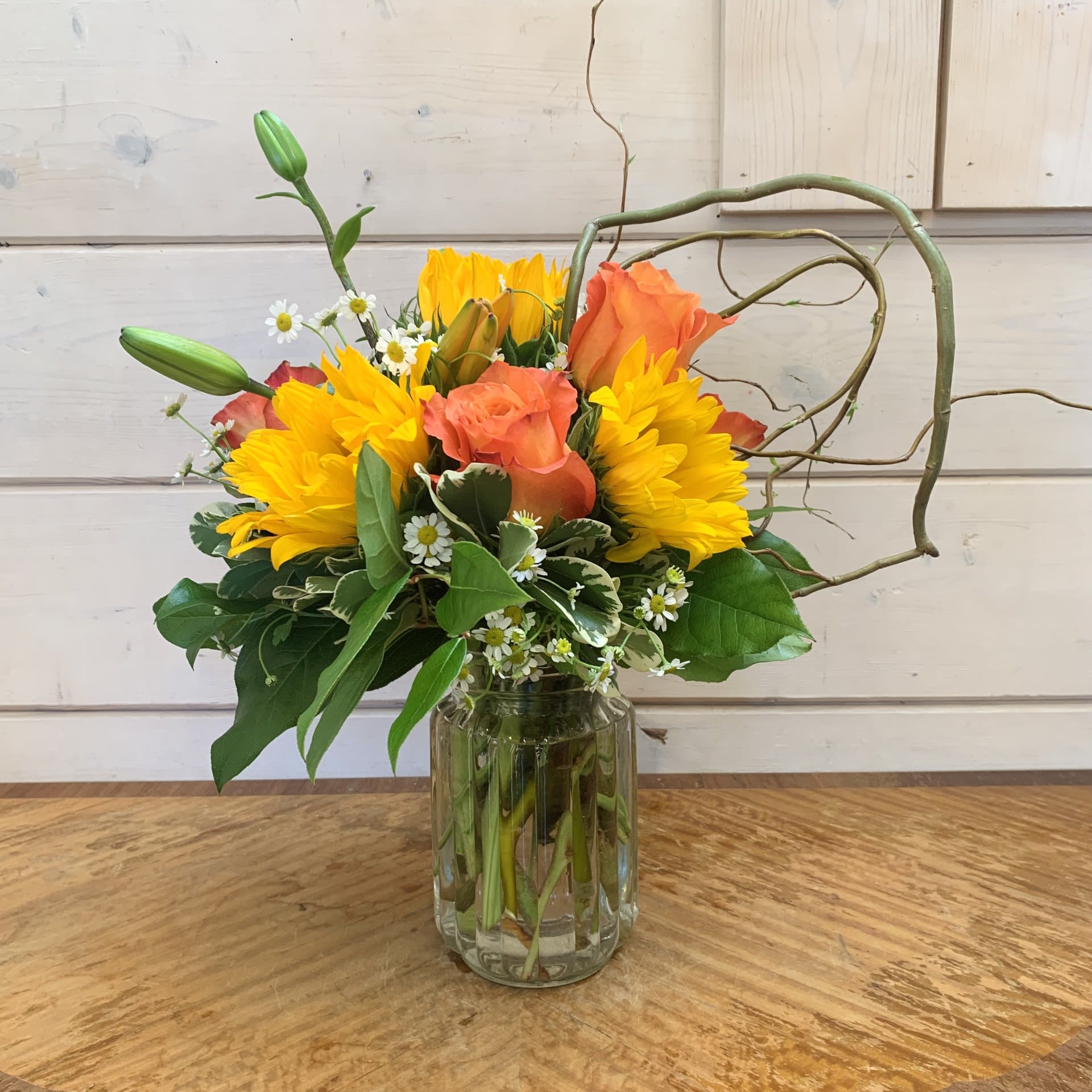 Bouquet of yellow and orange flowers in a glass vase