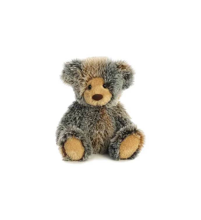 Small plush teddy bear with shaggy gray and brown fur sitting upright.