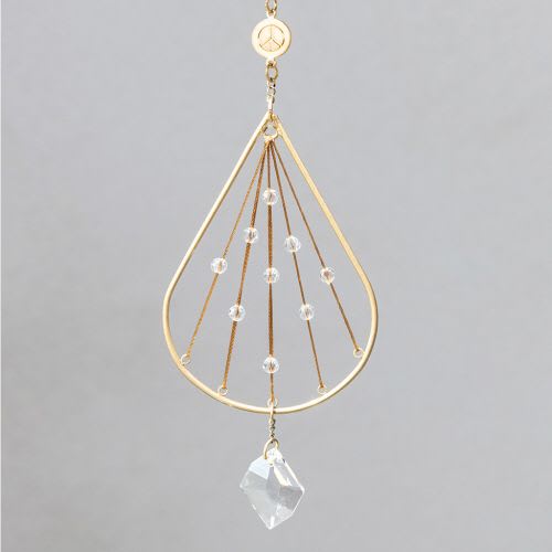 Gold teardrop hanging ornament with radiating strings, clear beads, and a faceted crystal drop
