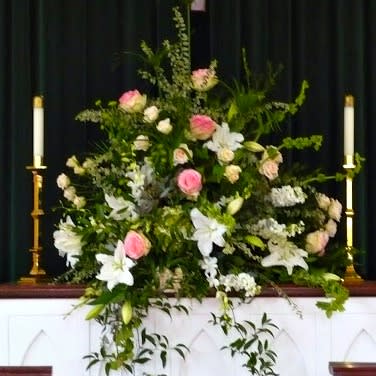 Garden Blush - When you need to send thoughts of condolence, we provide beautiful expressions in floral creativity. This one features soft pinks and neutral whites with contrasting greens, perfect for  feminine thoughts. For masculine styles, we will use darker colors. Seasonal florals vary. SYA-100 Garden Blush
