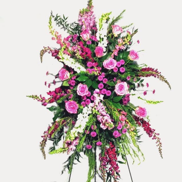 Sympathy - Loving Tributes - A Heartfelt Gesture of Love and Compassion The "Sympathy - Tribute" is a beautiful way to express your love and compassion during difficult times. This arrangement features fresh flowers with a garden-like feel, offering a comforting gesture that says, "I care about you." Thoughtful Design: Our standing sprays are available in various sizes and types, allowing you to choose the perfect tribute to show how much you care. Personalized Touch: We coordinate the colors of the flowers according to the appropriate age and gender, ensuring a personalized and respectful tribute. Elegant Example: Shown is an example of pink and white flowers, symbolizing purity and love, which we can provide for you. Choose the "Sympathy - Loving Tribute" from Elizabeth's Garden to convey your heartfelt condolences and support, offering a meaningful and comforting gesture to those in need.