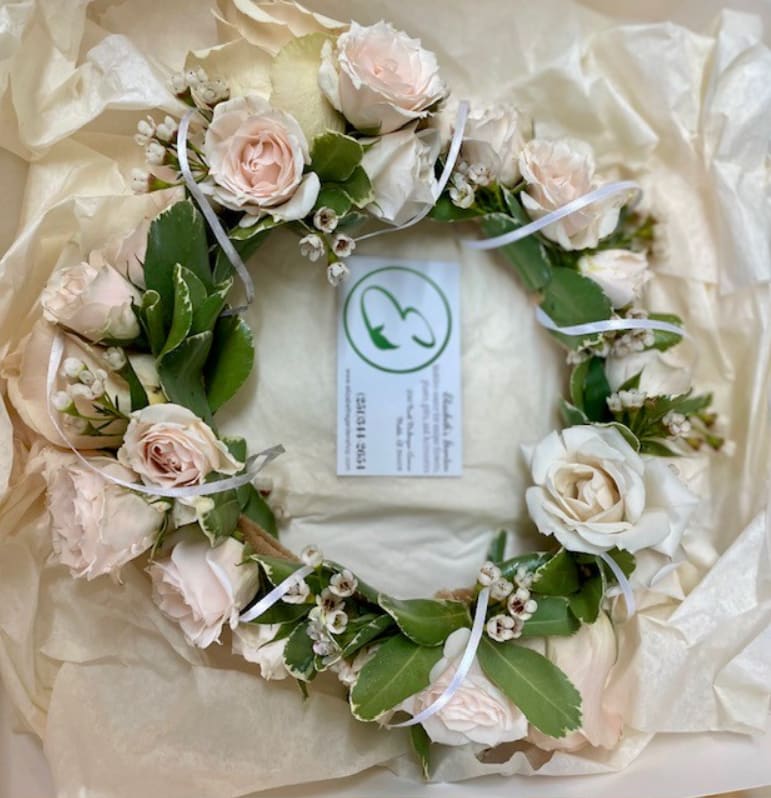 Floral Crown / Halo - Customizable - Create unforgettable memories with our Customizable Floral Crown or Halo, a stunning headpiece tailored to reflect your unique style and preferences. Designed with a ring of fresh natural foliage, this crown can be personalized with seasonal flowers and colors to match your vision. Perfect for confirmations, serving girls, proms, homecoming dances, recitals, weddings, Camellia Ball, and other cherished celebrations, this crown radiates timeless beauty and effortless grace. -Key Features: **Customizable Florals: Choose from a variety of seasonal flowers, colors, and designs to create a crown perfectly suited to your event and outfit. **Fresh Natural Foliage: A lush and organic base that provides a natural and elegant foundation for the design. **Delicate Baby’s Breath: Adds an ethereal, romantic touch to the crown’s overall aesthetic. **Charming Tiny Roses: Petite roses bring sophistication and a touch of classic beauty to the piece. **Lightweight and Comfortable: Designed with all-day wear in mind, ensuring both comfort and style. -Benefits: **Fully customizable to complement your event’s theme, color palette, or personal preferences. **Versatile enough to pair with a variety of hairstyles and outfits. Whether you’re looking for a bold, colorful statement piece or a soft, romantic design, our Floral Crown or Halo is the ideal accessory to complete your special day. Order yours today and let its personalized charm and elegance make your celebration truly one-of-a-kind!
