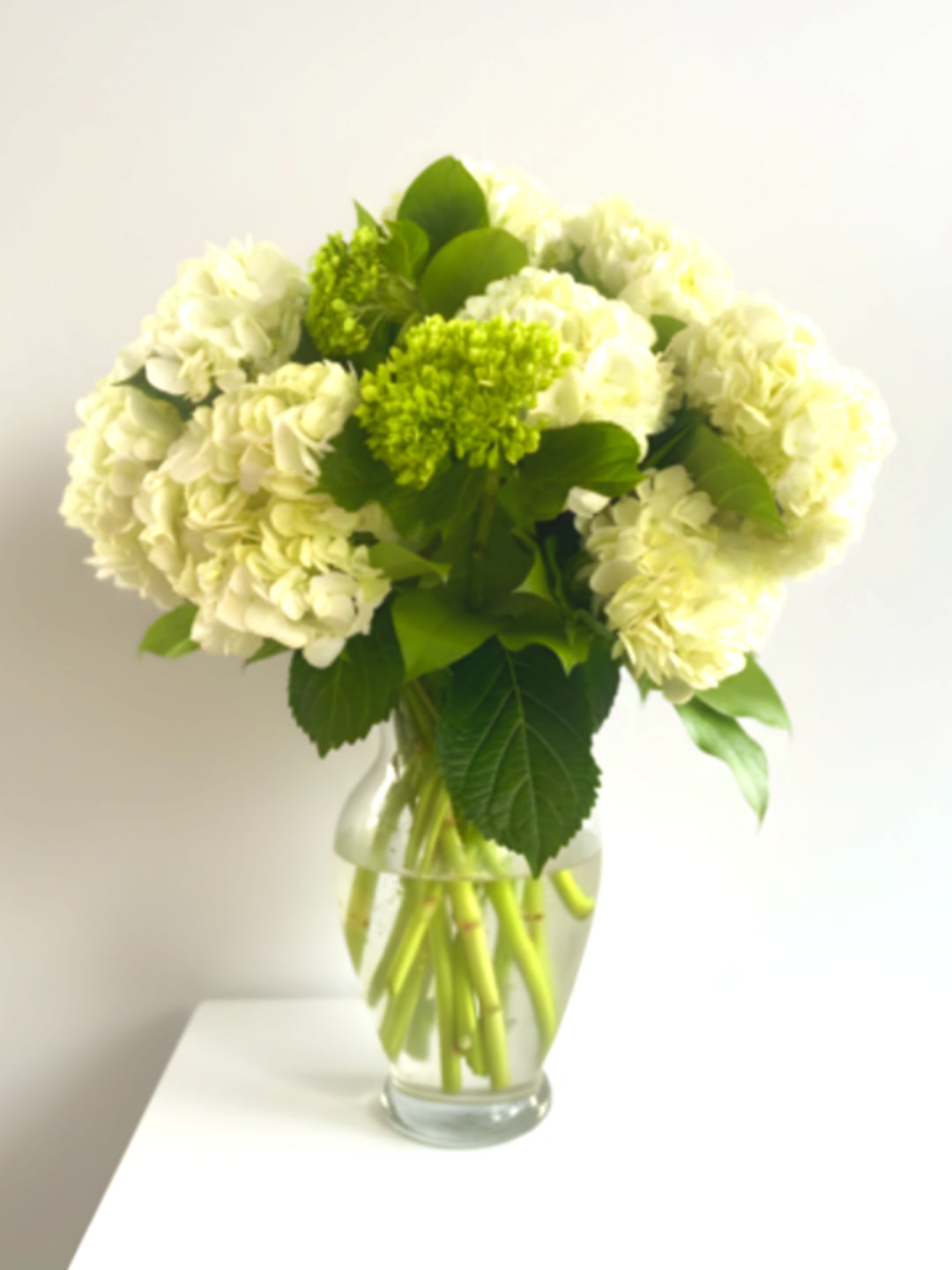 White hydrangea bouquet in a clear glass vase