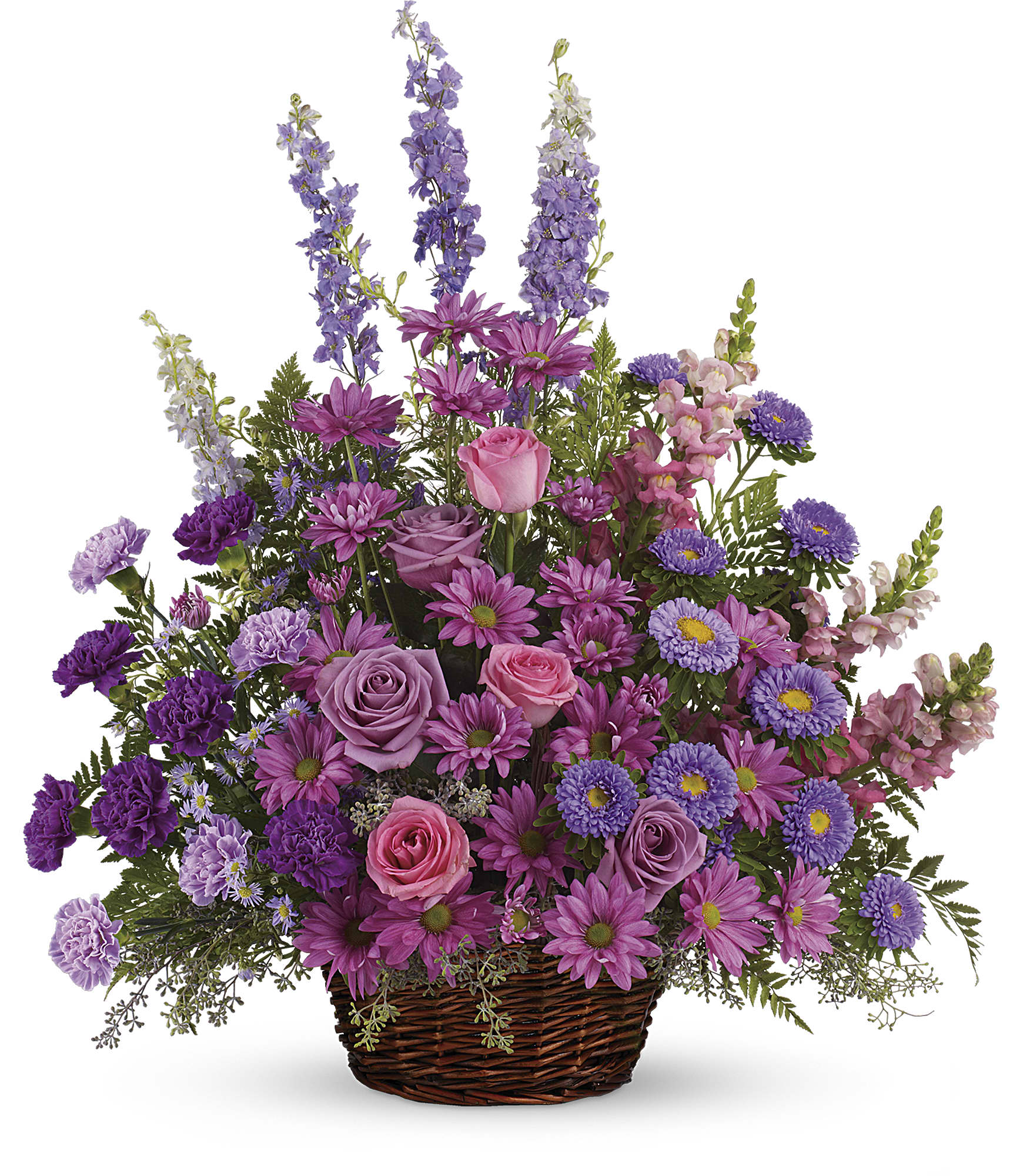 Purple and pink mixed flower arrangement in a wicker basket