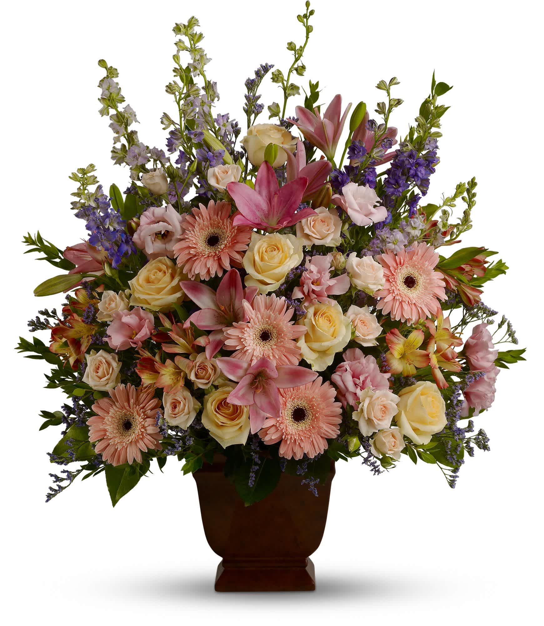 Mixed pink and cream flowers in a brown urn vase