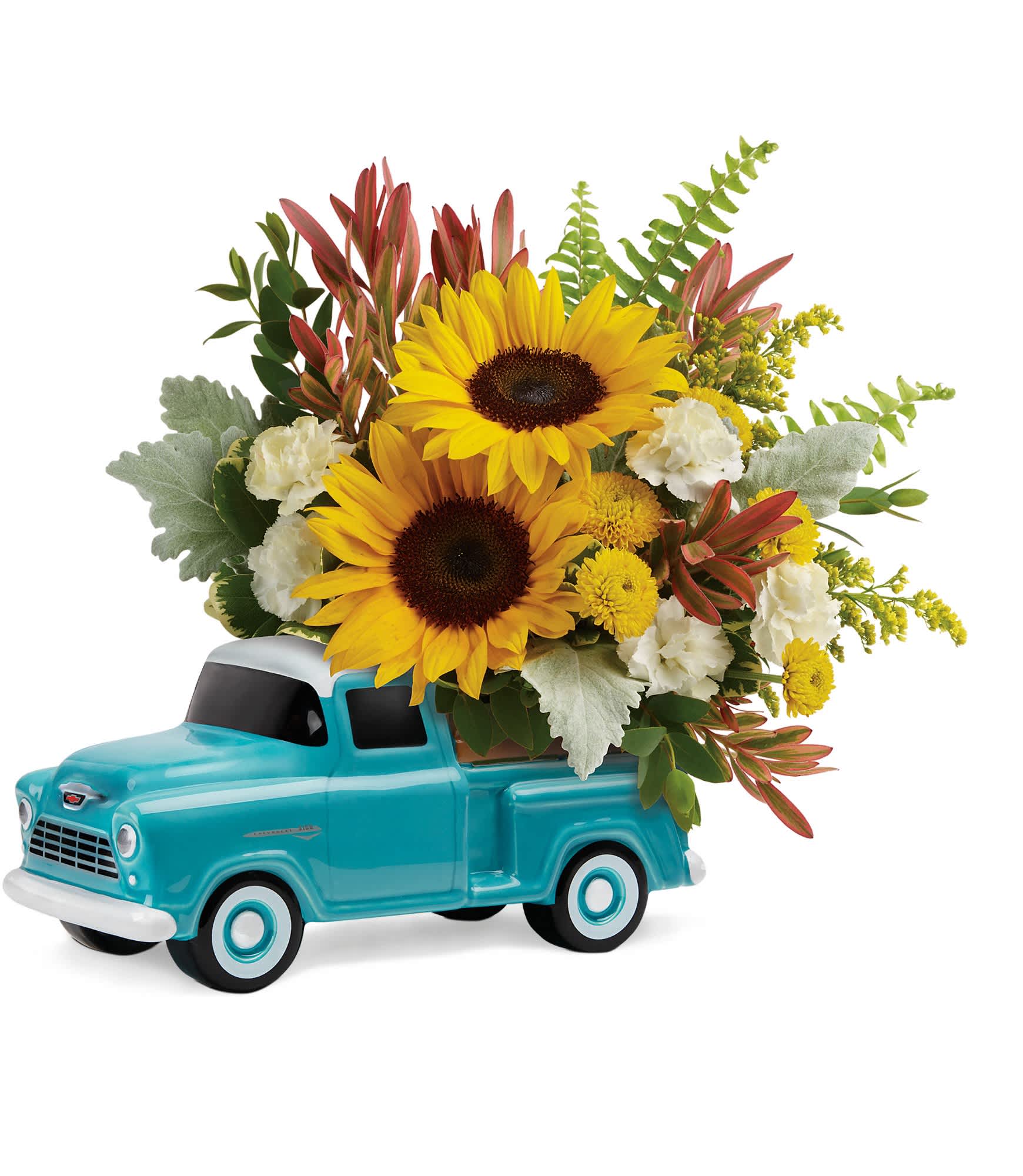 Sunflowers and white carnations arranged in a turquoise pickup truck container