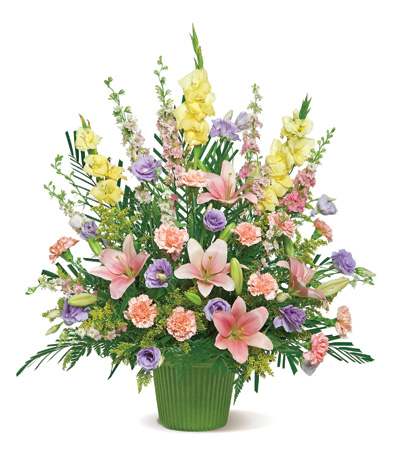 Mixed bouquet of lilies, carnations, and purple blooms in a green vase