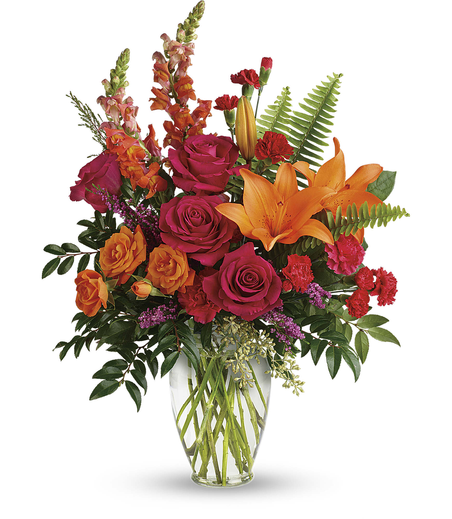 Bright mixed bouquet with roses, lilies, and snapdragons in a clear vase