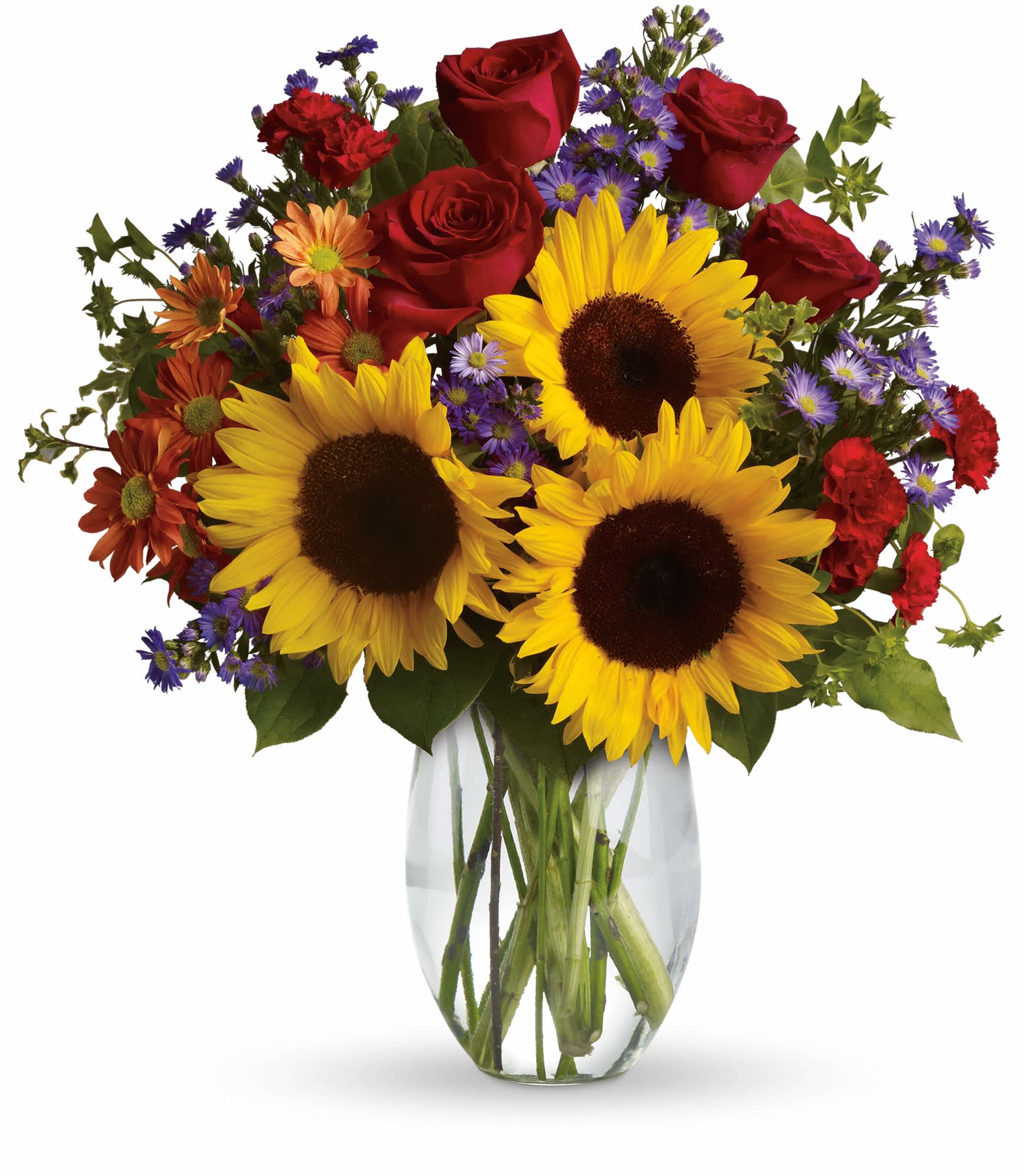 Bouquet of sunflowers, red roses, and purple daisies in a clear glass vase