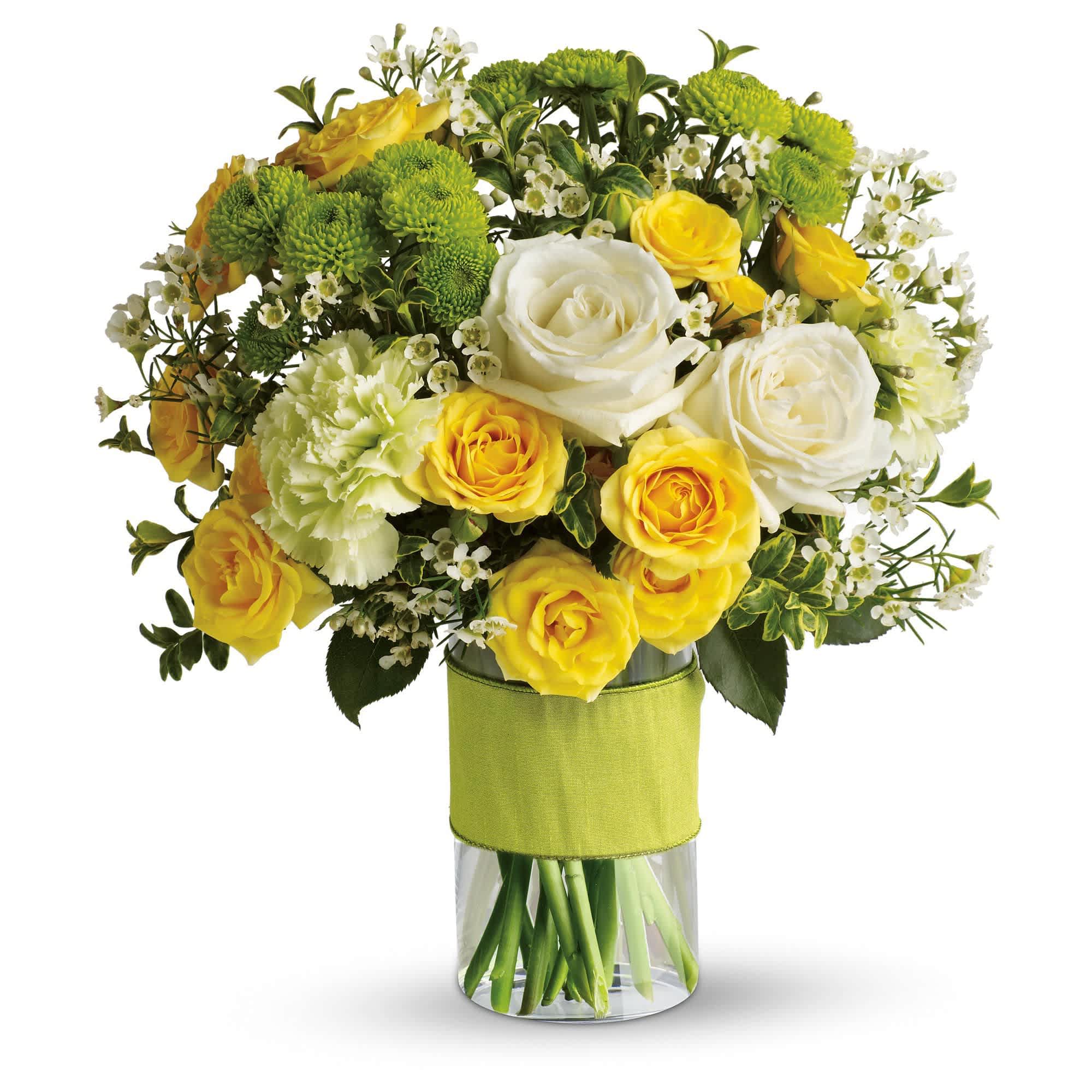Yellow and white rose bouquet in a clear vase with green mums