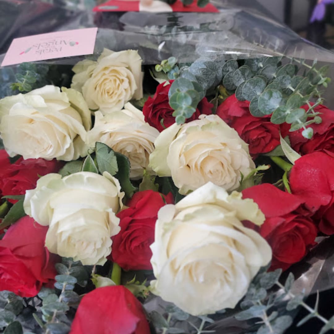 Bouquet of red and white roses with eucalyptus in clear wrap
