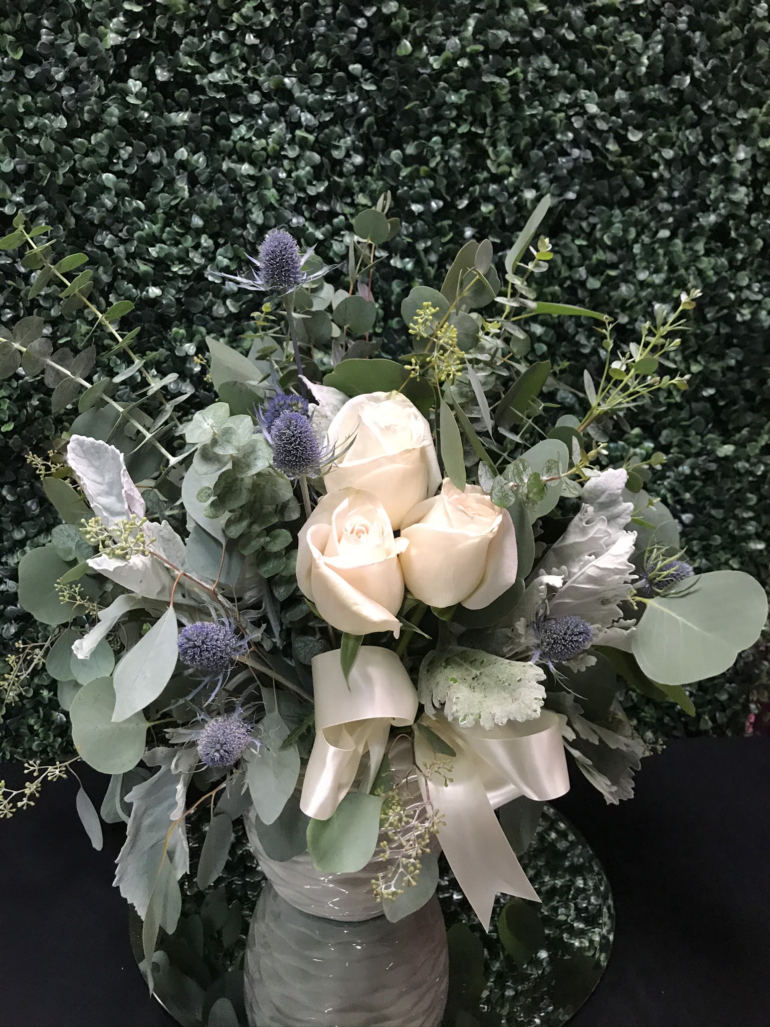 Peace Fragance PLA72 - Eucalyptus and various greenery adorned with delightful white roses, arranged in a ceramic vase to fill the room with a lovely fragrance 