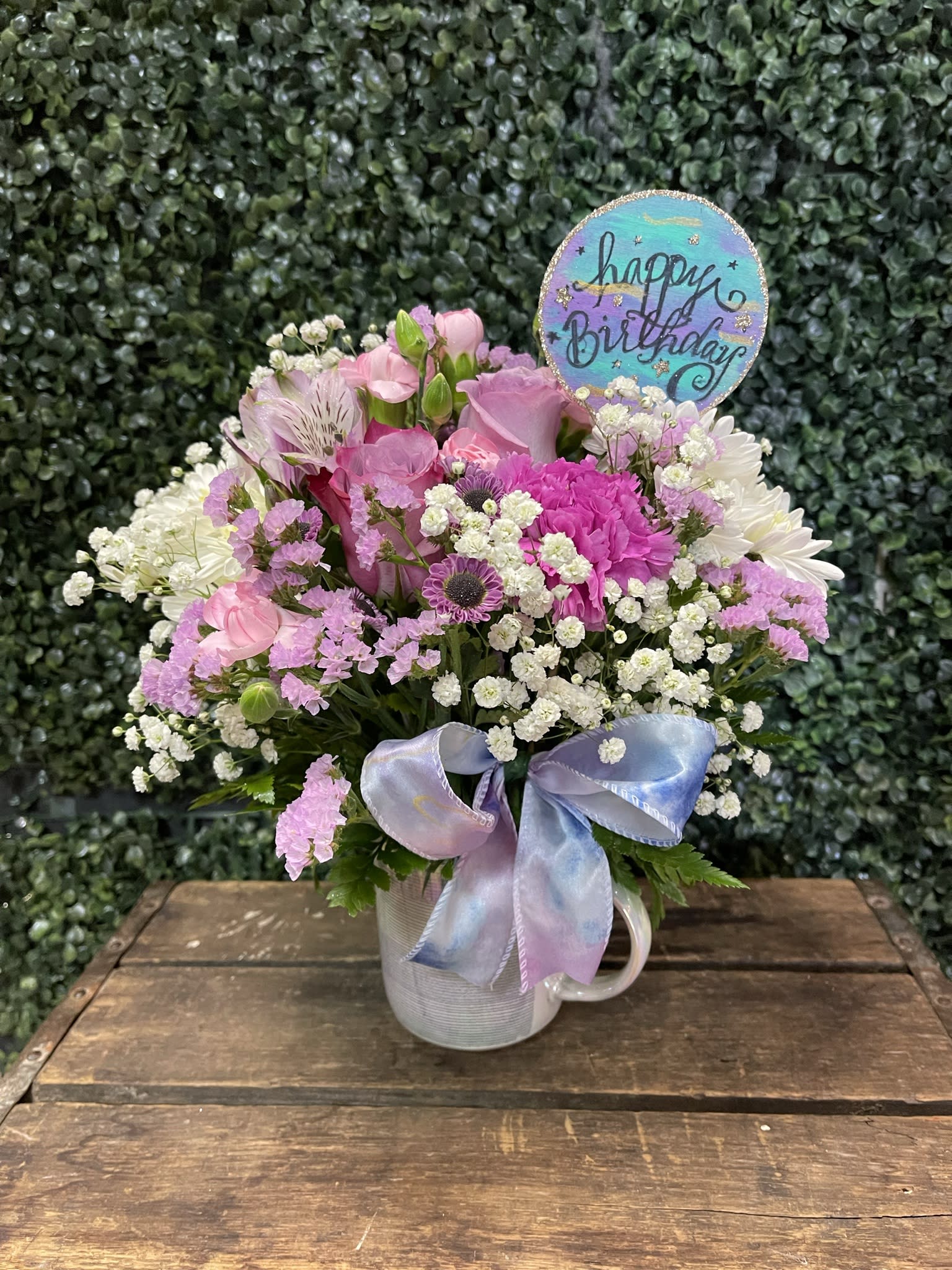 Pink and white mixed bouquet in a mug with a birthday sign and ribbon