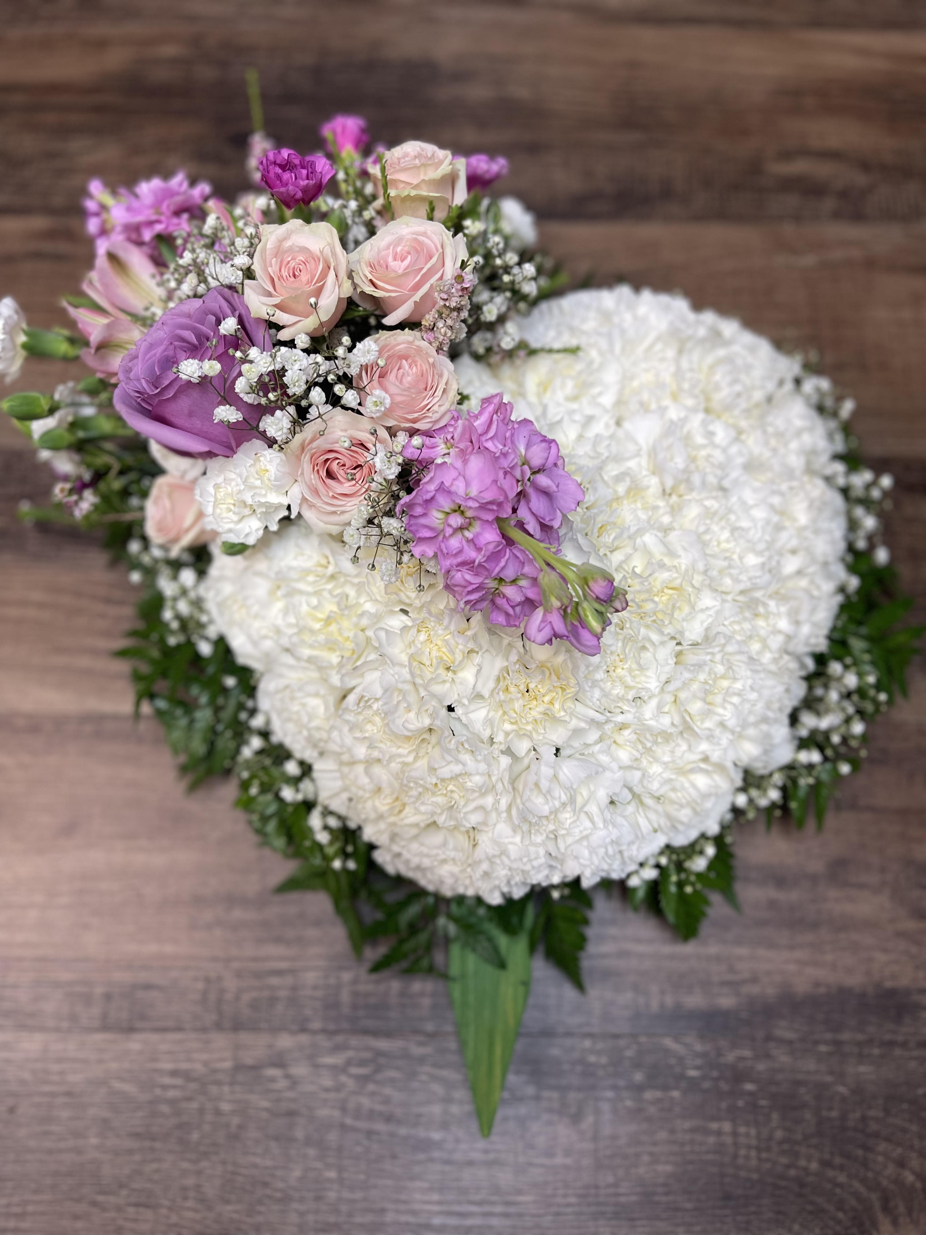 Heart-shaped bouquet of white and pink flowers with purple accents