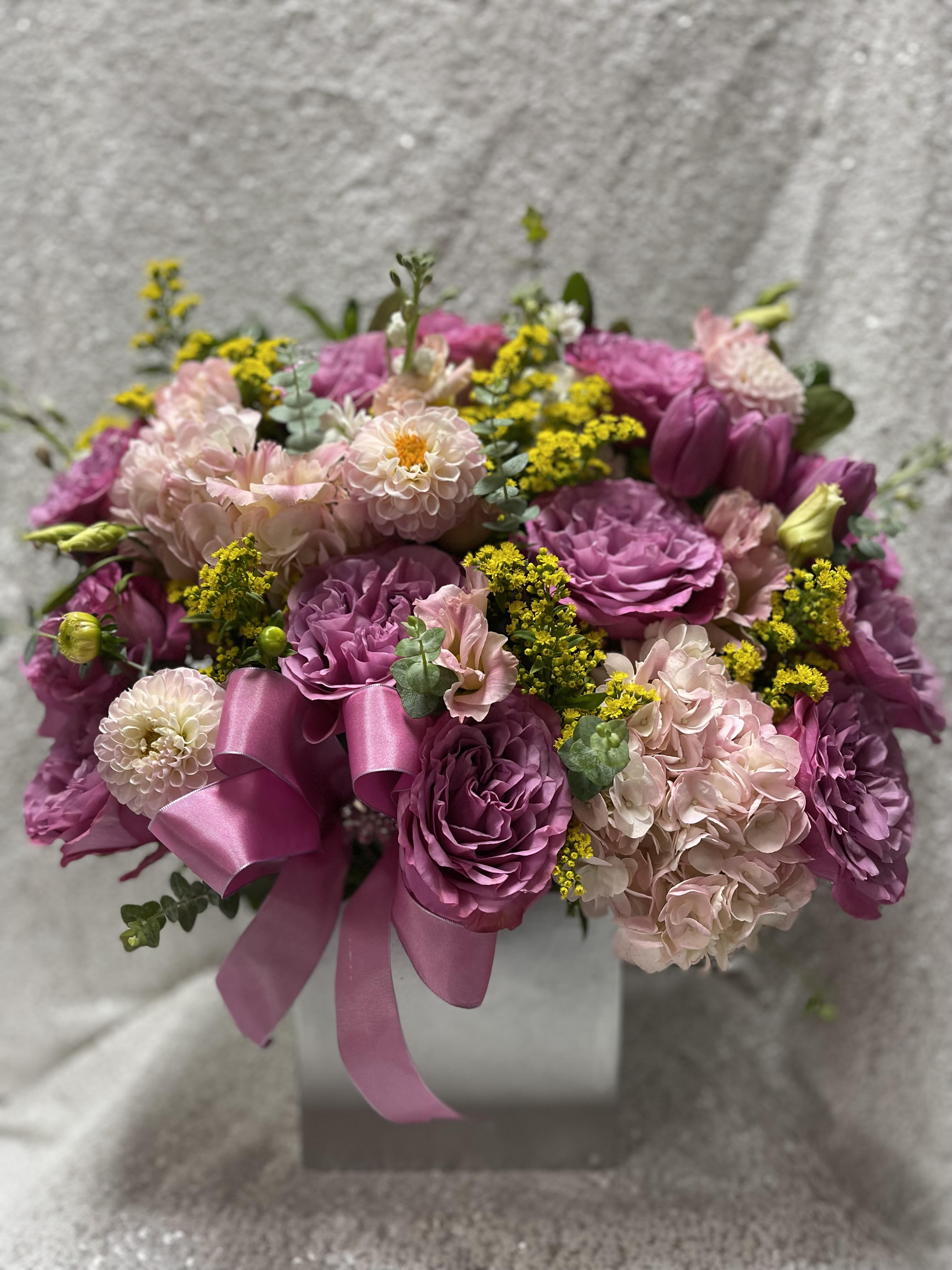 Pink and purple bouquet with a satin ribbon in a box