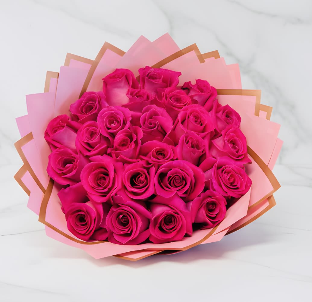 Bouquet of bright hot pink roses wrapped in layered pink and peach paper