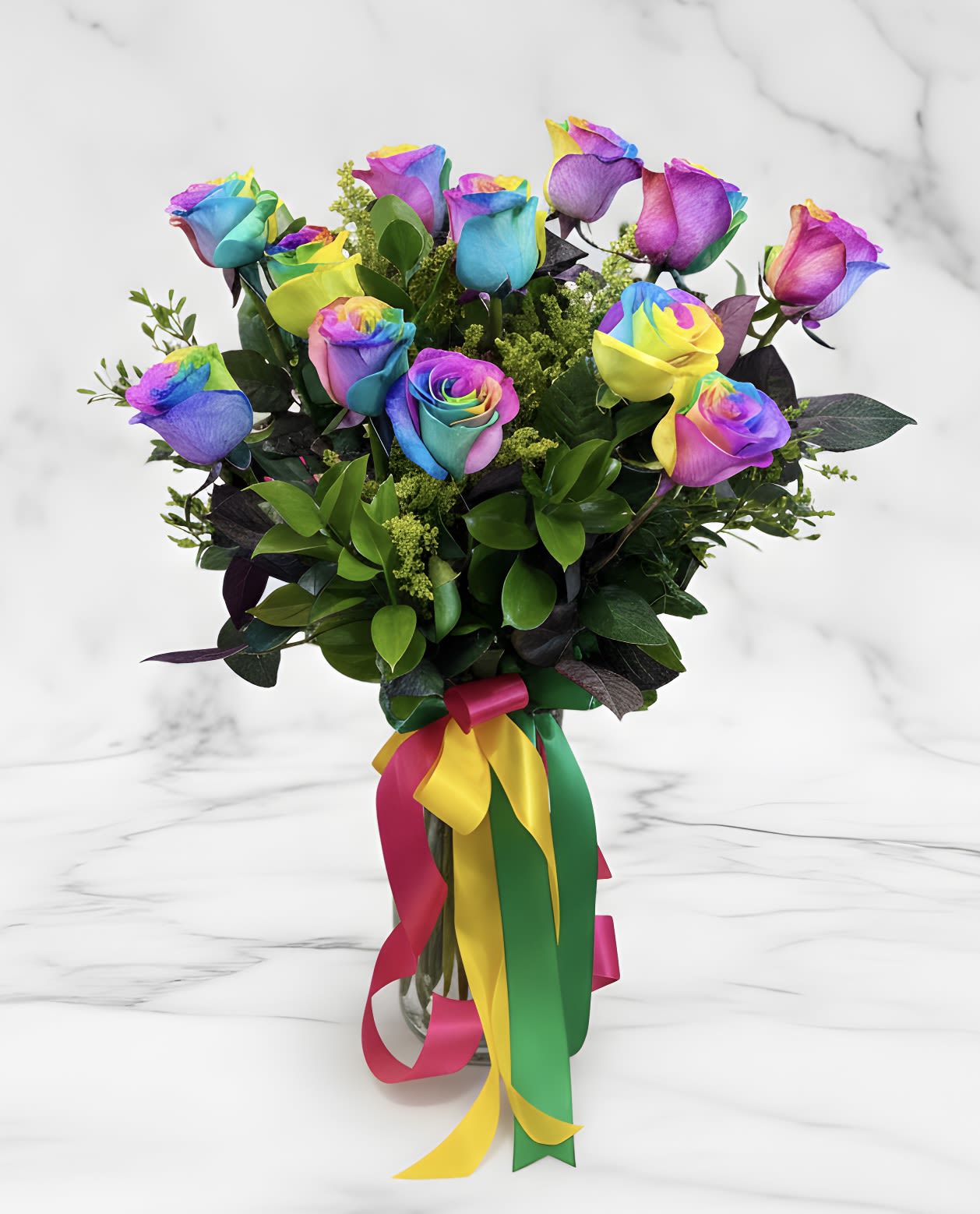 Bouquet of rainbow-colored roses in a glass vase with multicolor ribbons