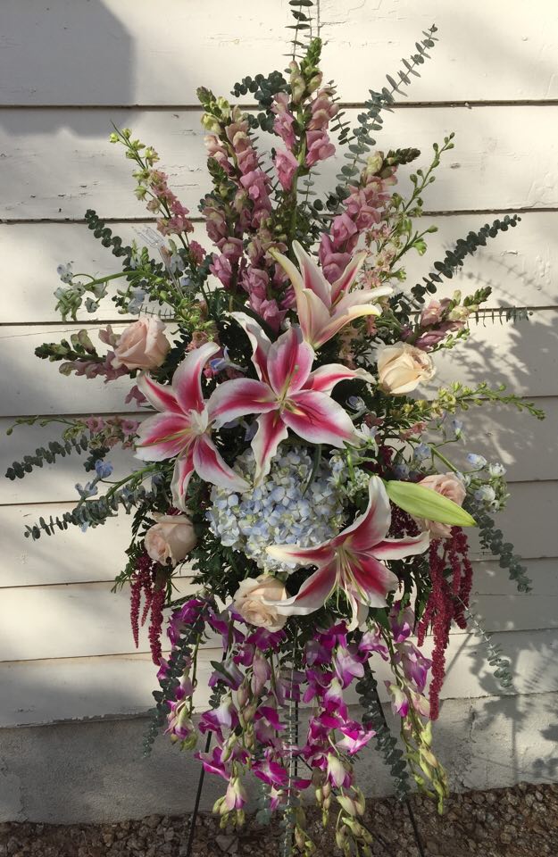Tall floral spray with pink lilies, roses, and purple blooms