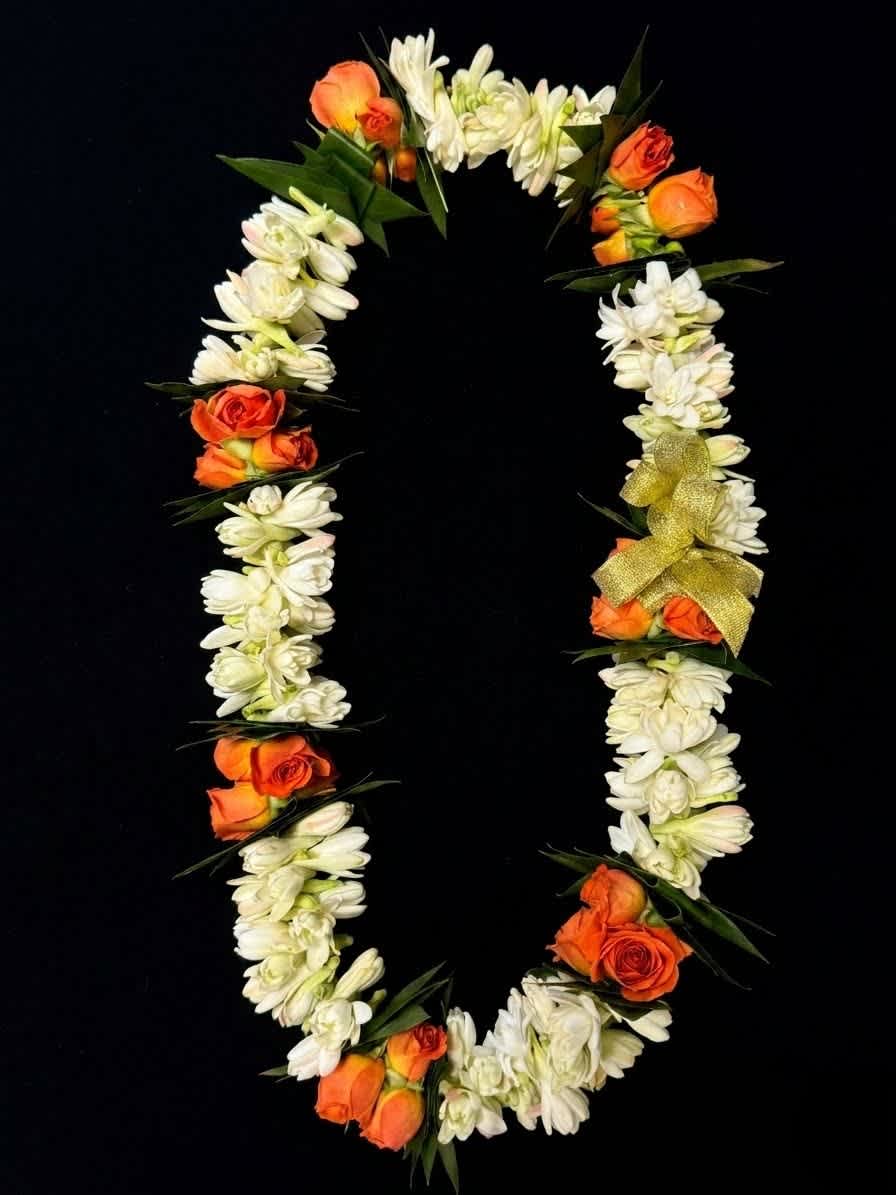 Orange roses and white flowers arranged in a floral garland