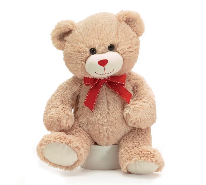 Plush teddy bear with a red ribbon bow