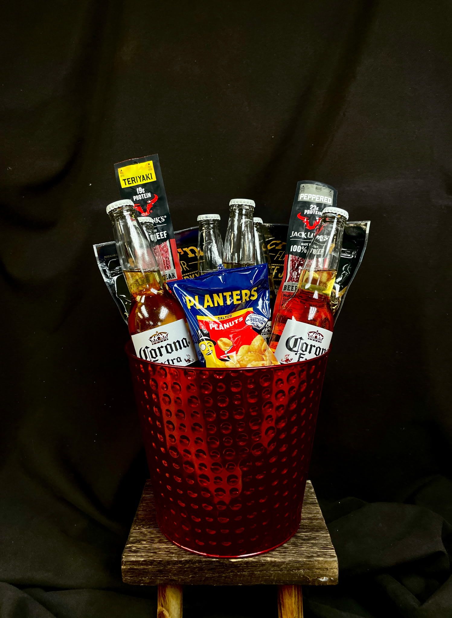 Gift bucket with beer bottles, jerky packs, and peanuts