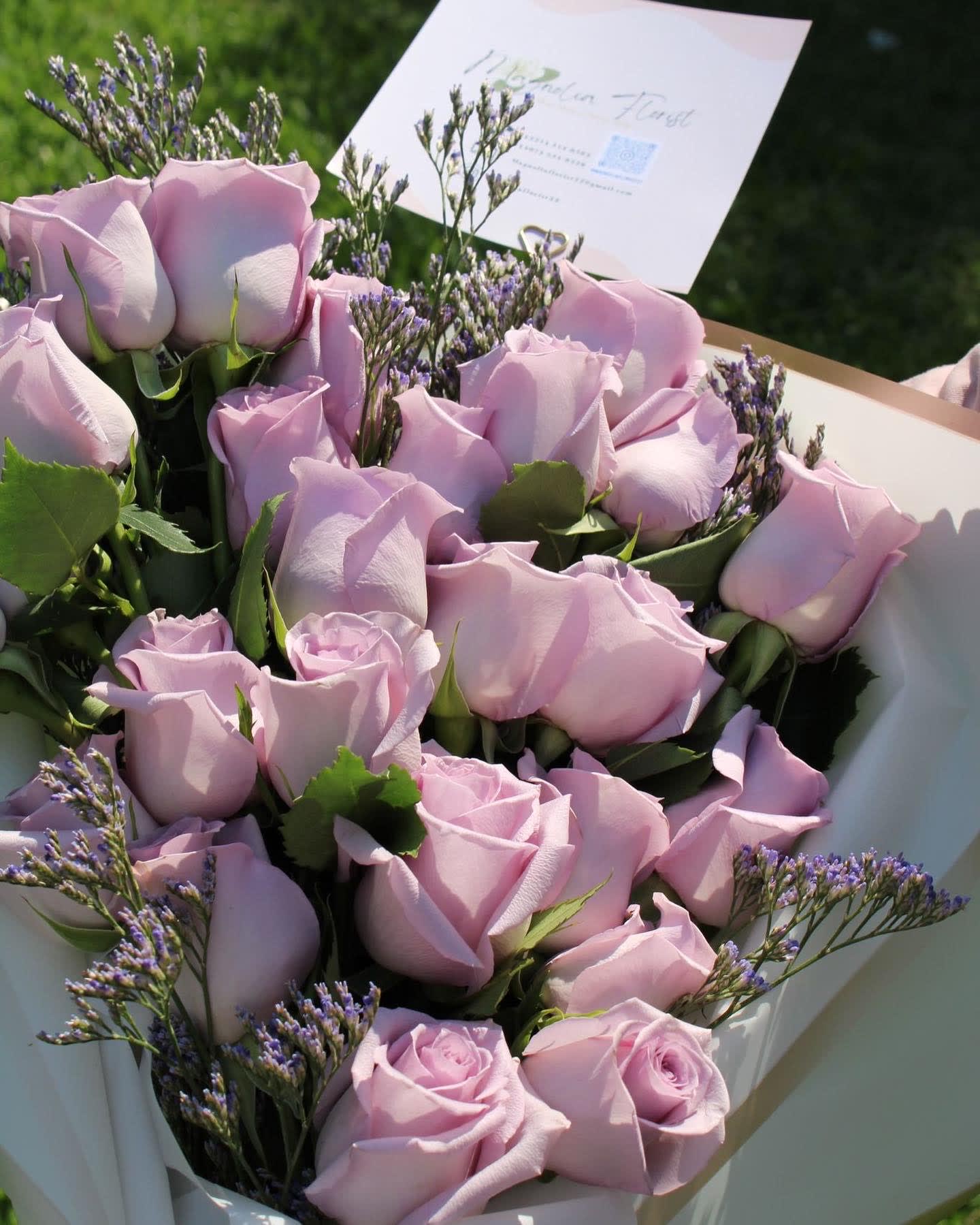 Bouquet of pale pink roses with purple filler flowers