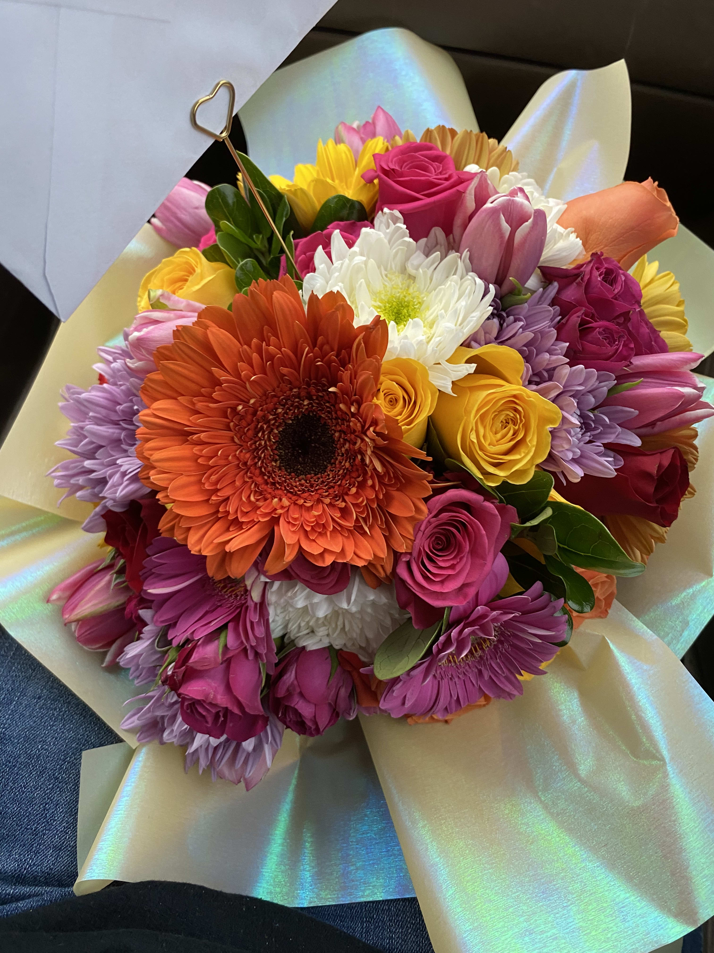 Bright mixed bouquet with roses, gerbera daisies, tulips, and chrysanthemums