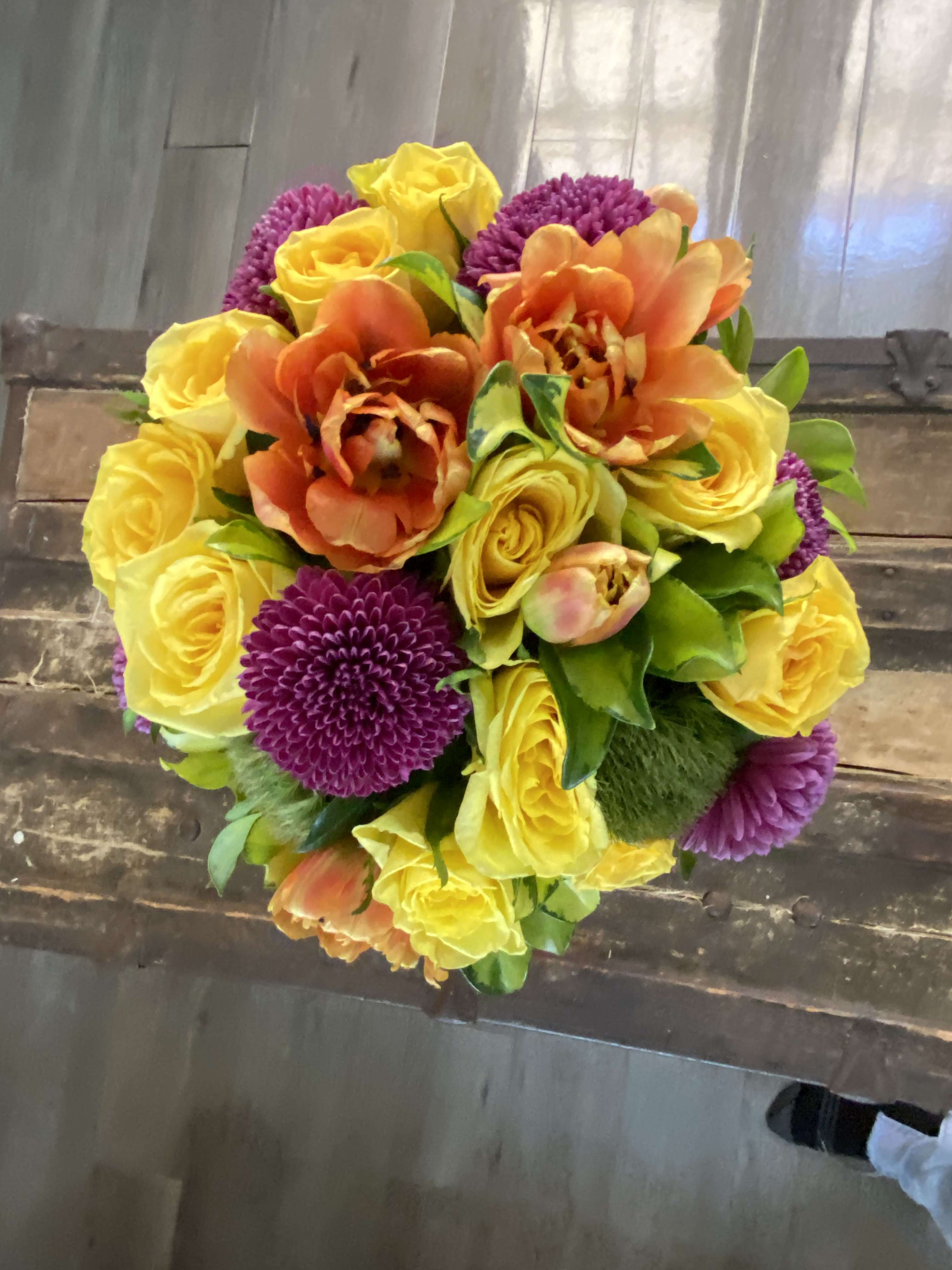 Bouquet of yellow roses, orange tulips, and purple mums