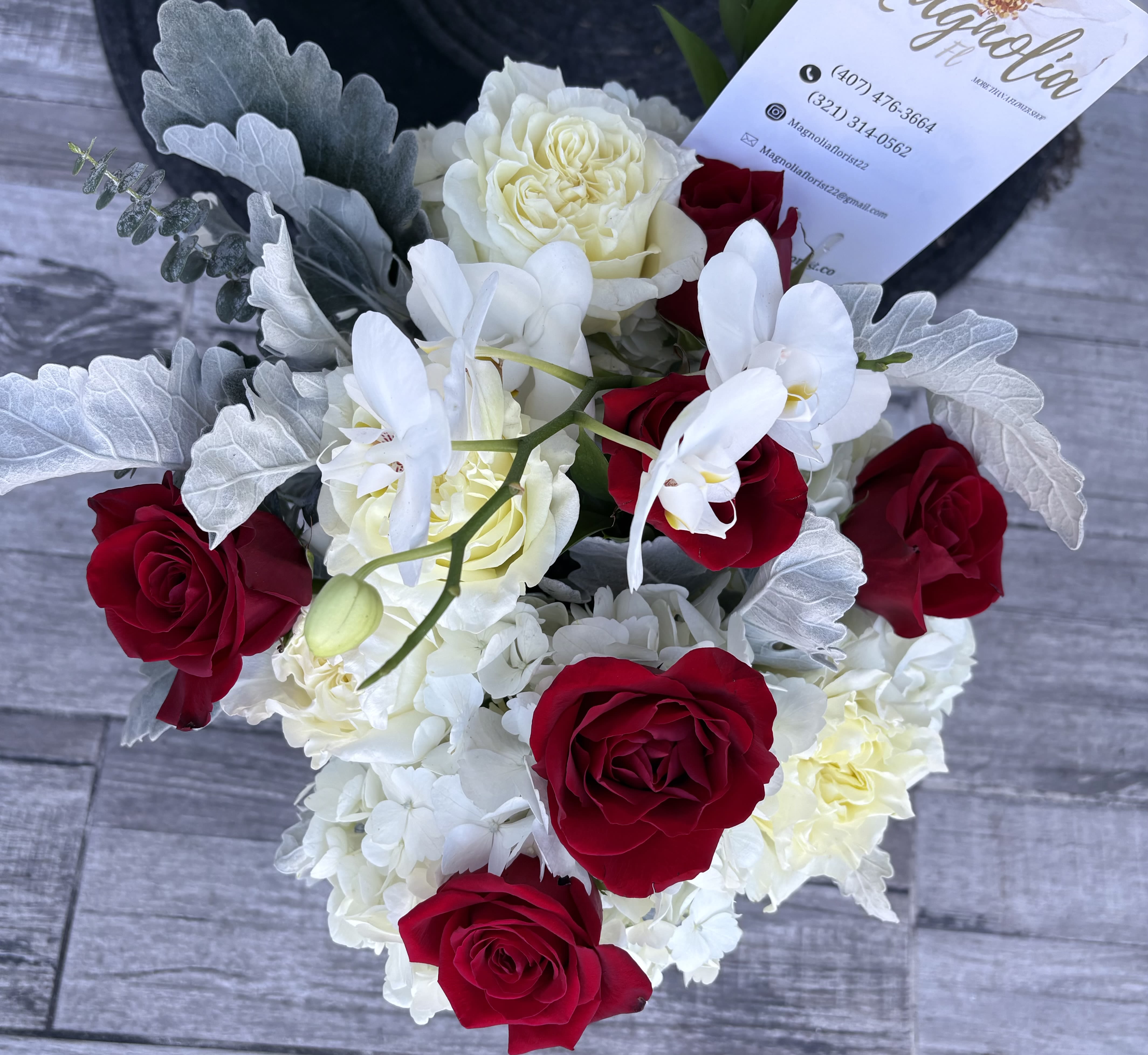 Bouquet of red and white roses with white orchids