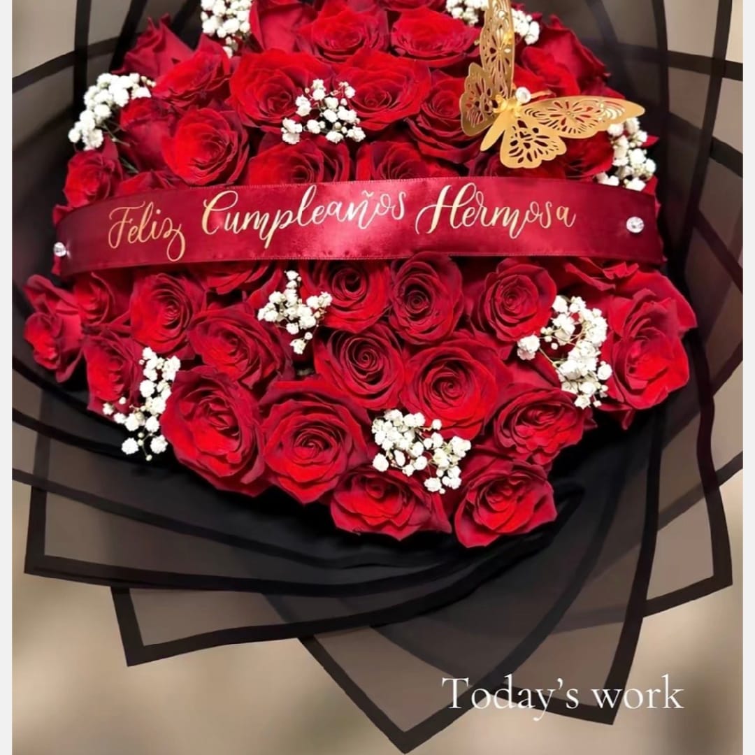 Red rose bouquet with white baby's breath and a birthday ribbon