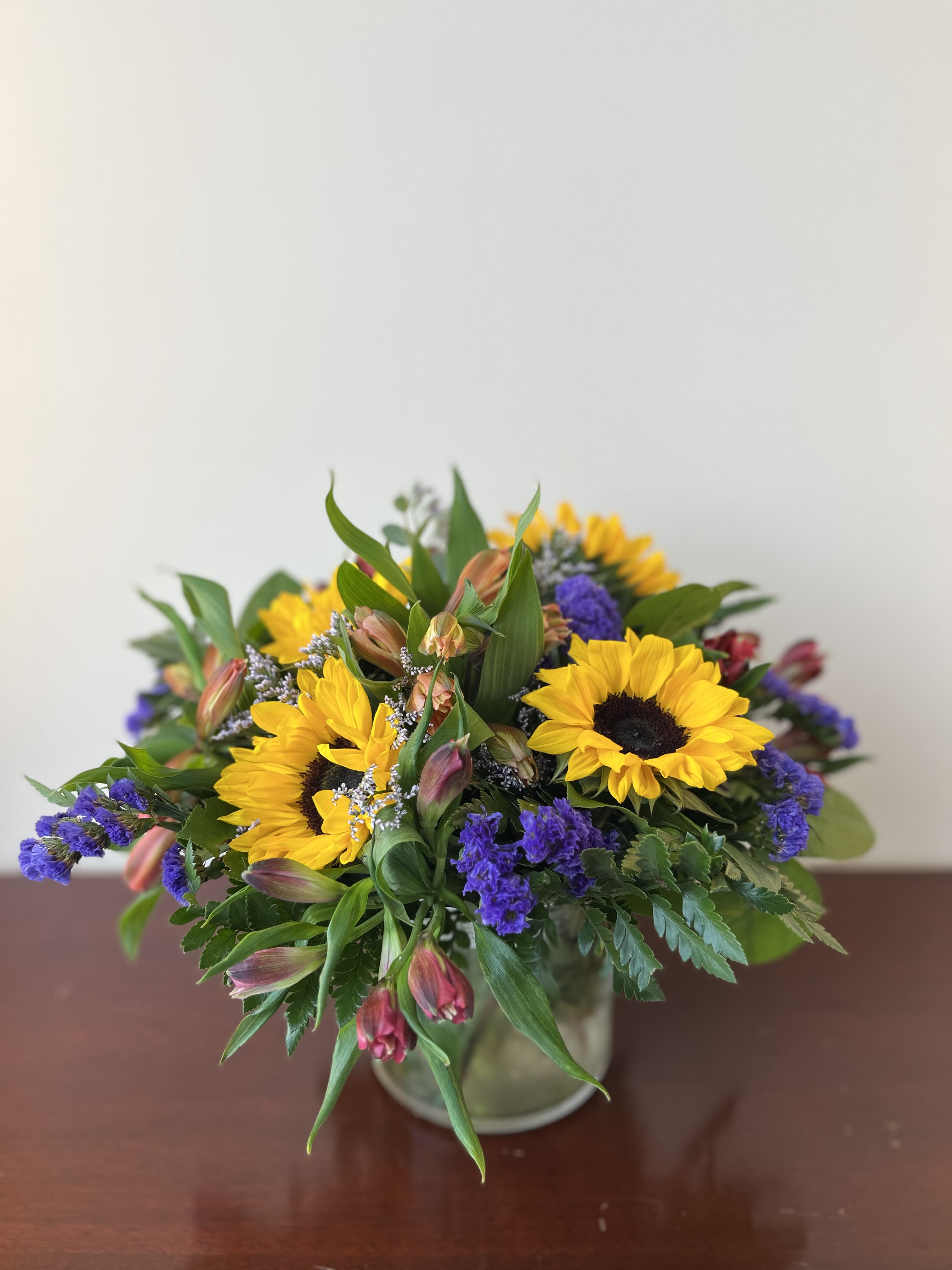 ALONG THE TRED AVON - SUNFLOWERS ARE THE PERFECT BLOOM FOR THIS TRANSITION INTO THE COOLER CRISP DAYS OF AUTUMN FOR YOUR HOME.  THIS COLLECTION BE SURE TO SEND THIS COLLECTION OF SUNFLOWERS AND ASSORTED BLOSSOMS.
