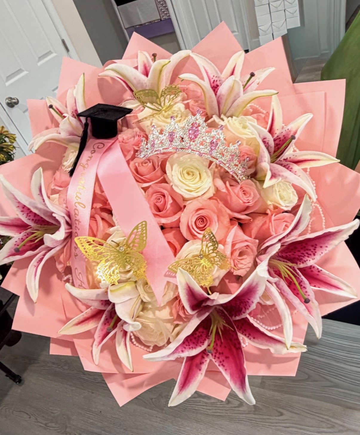 Congratulation bouquet  - pink congratulation bouquet perfect of any occasion or achievement. This bouquet comes with 50 fresh pink roses and 7 pink lilies ,a stunning pink crown, and a custom ribbon 