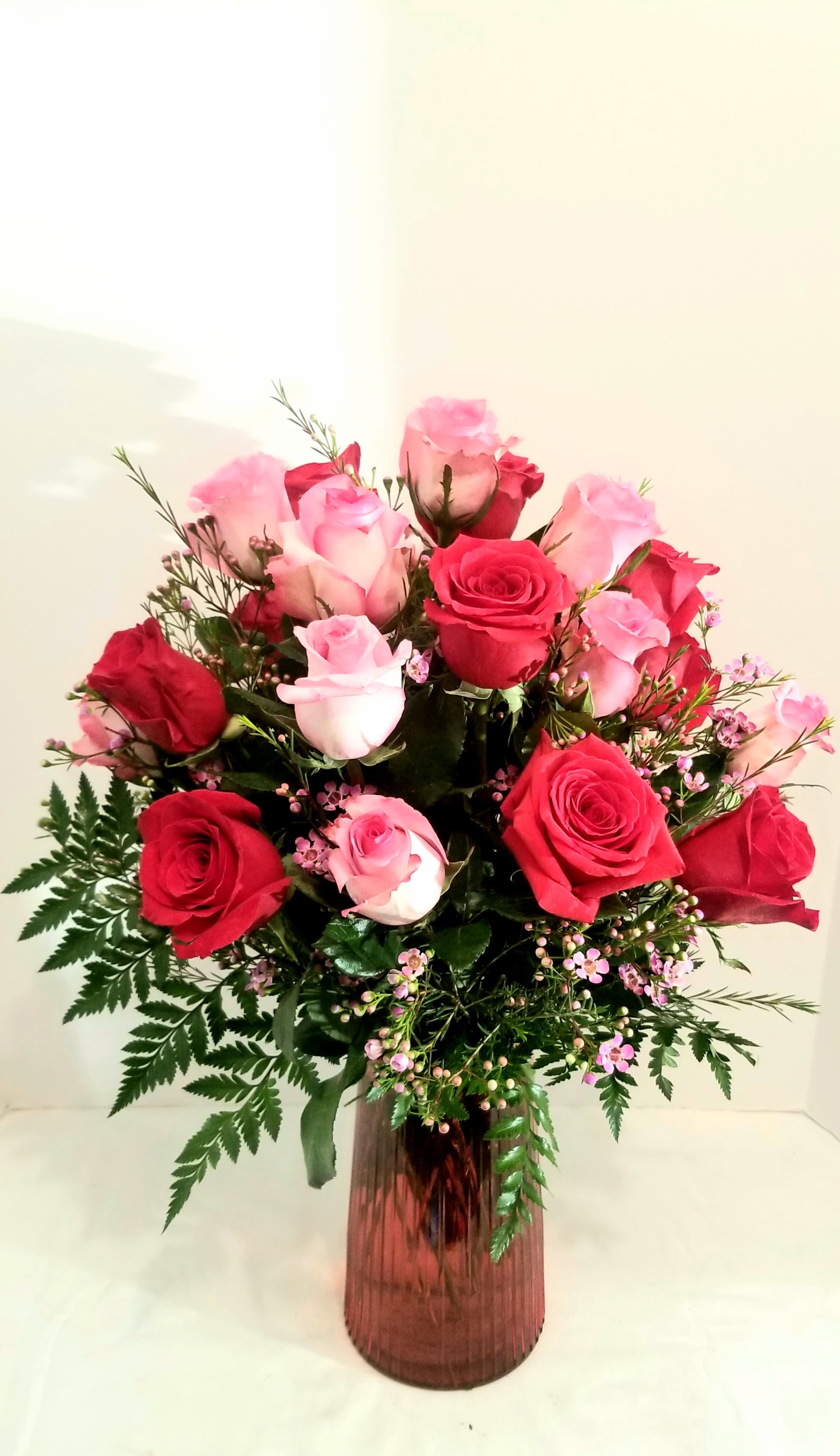 Roses -  Pink and Red - She'll be blushing for sure when our beautiful bouquet of pink and red  roses arrive at the door! Hand-gathered by our professional designers in a (red if available) vase, we can't think of a more colorful way to express yourself to someone very special.  Standard arrangement consists of  12  roses, Deluxe arrangement consists of 18 roses and  Premium consists of  24 roses.  We  select the freshest flowers available therefore the  colors and varieties may vary.