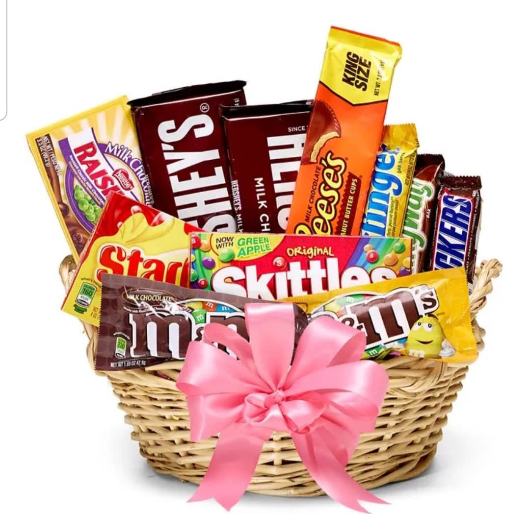 Basket of assorted candy bars and chocolates with a pink bow