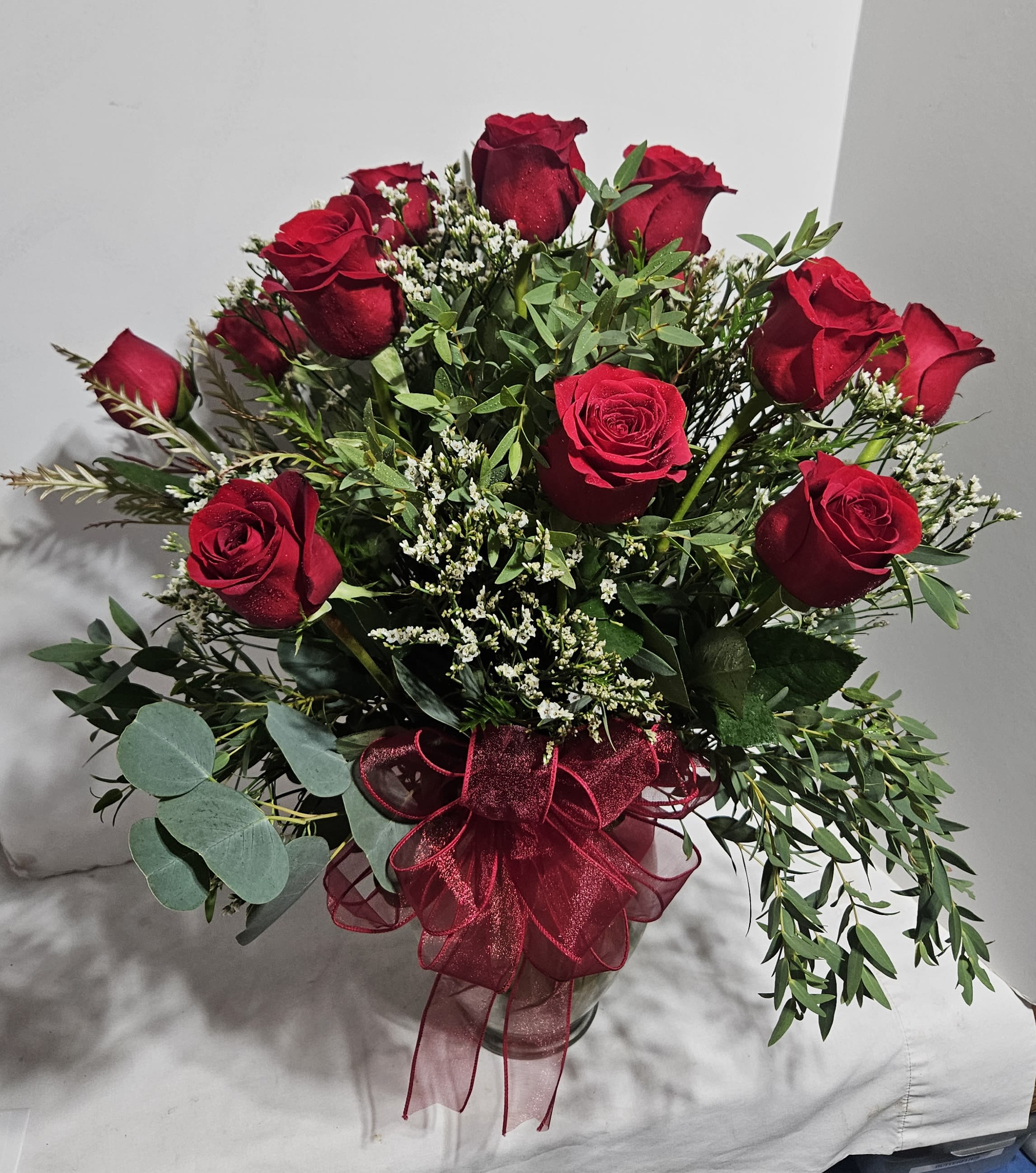 Elegant Red Roses - Red roses are just the gift for someone special. Give the ultimate expression with this stunning, handcrafted arrangement of  red roses artistically arranged by FlowerBee floral artisans in a classic glass vase A gift of thoughtfulness or love they will always remember.  Available in bouquets of 12 stems - regular price; 18 stems - deluxe price; 24 stems - premium price.   To request a specific color, please note in special instructions.
