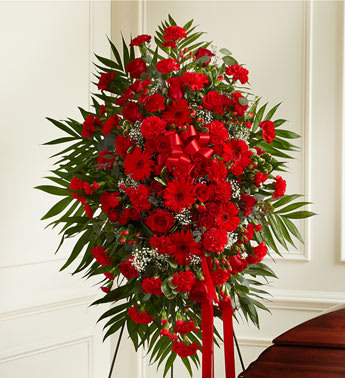 Deepest Sympathies Standing Spray - Red - This Sympathy Standing Spray, in beautiful red, is a touching symbol of your sympathy and support. Red flowers such as roses, Gerbera daisies, spray roses, carnations and more An appropriate gift for family, friends and business associates to send directly to the funeral home  FlowerBee floral artisans use only the freshest flowers available, so components may vary. To request a specific color scheme, please note in special instructions.
