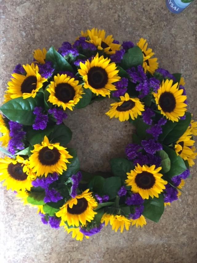 Sunflower wreath with purple filler flowers