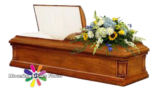 Wooden casket with a mixed floral spray on top