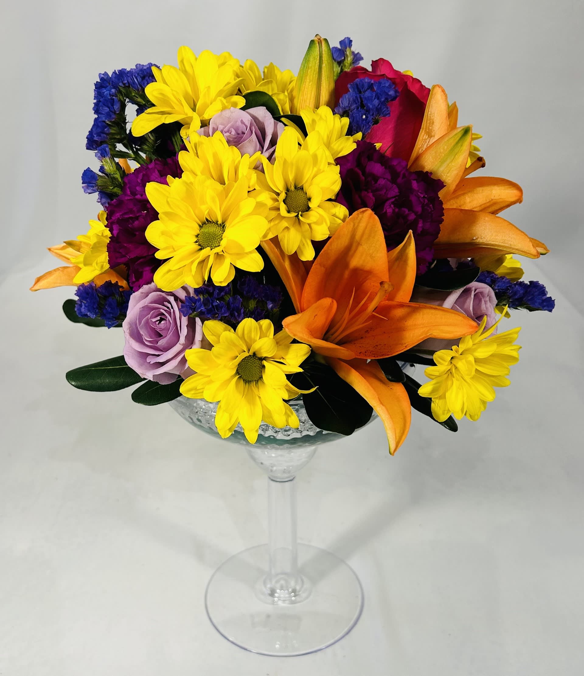 Colorful bouquet in a clear stemmed glass vase
