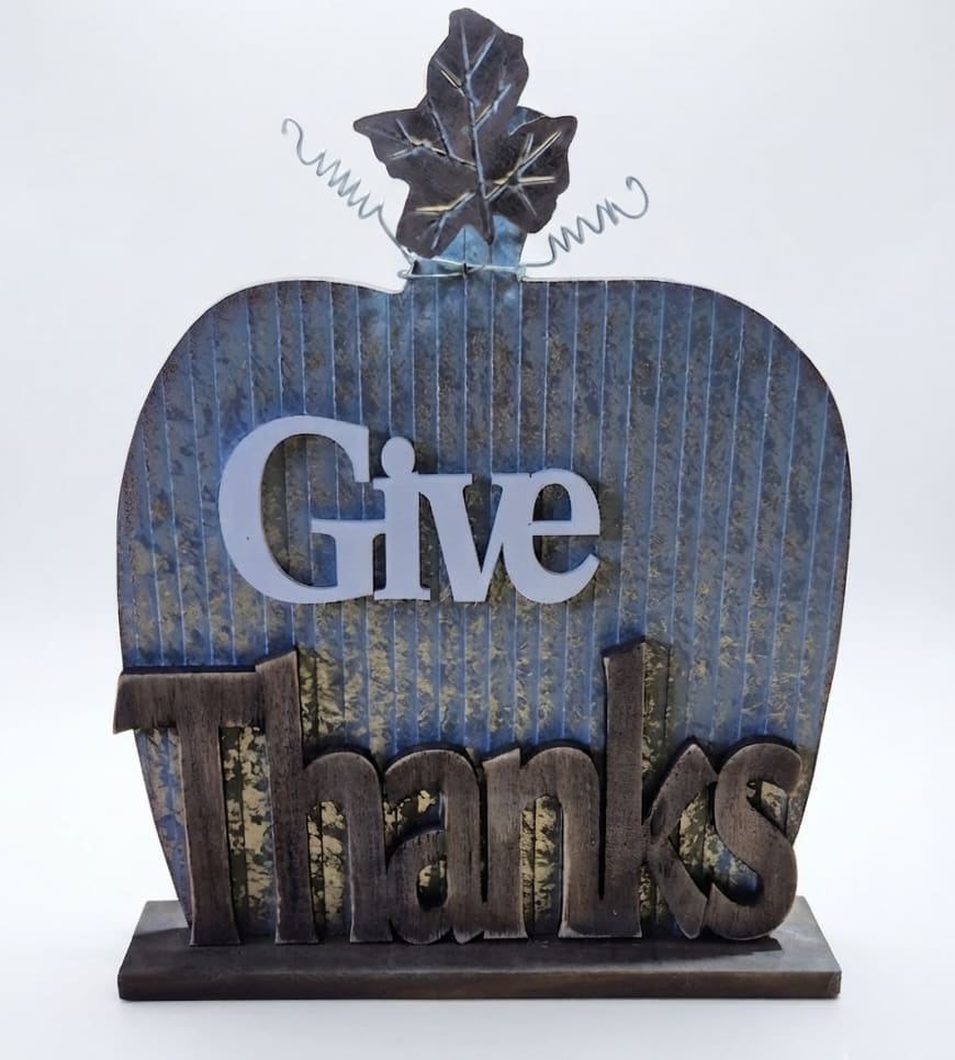 Decorative tabletop sign shaped like a pumpkin with the words Give Thanks