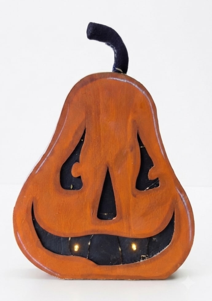 Wooden jack-o'-lantern decoration with a black stem